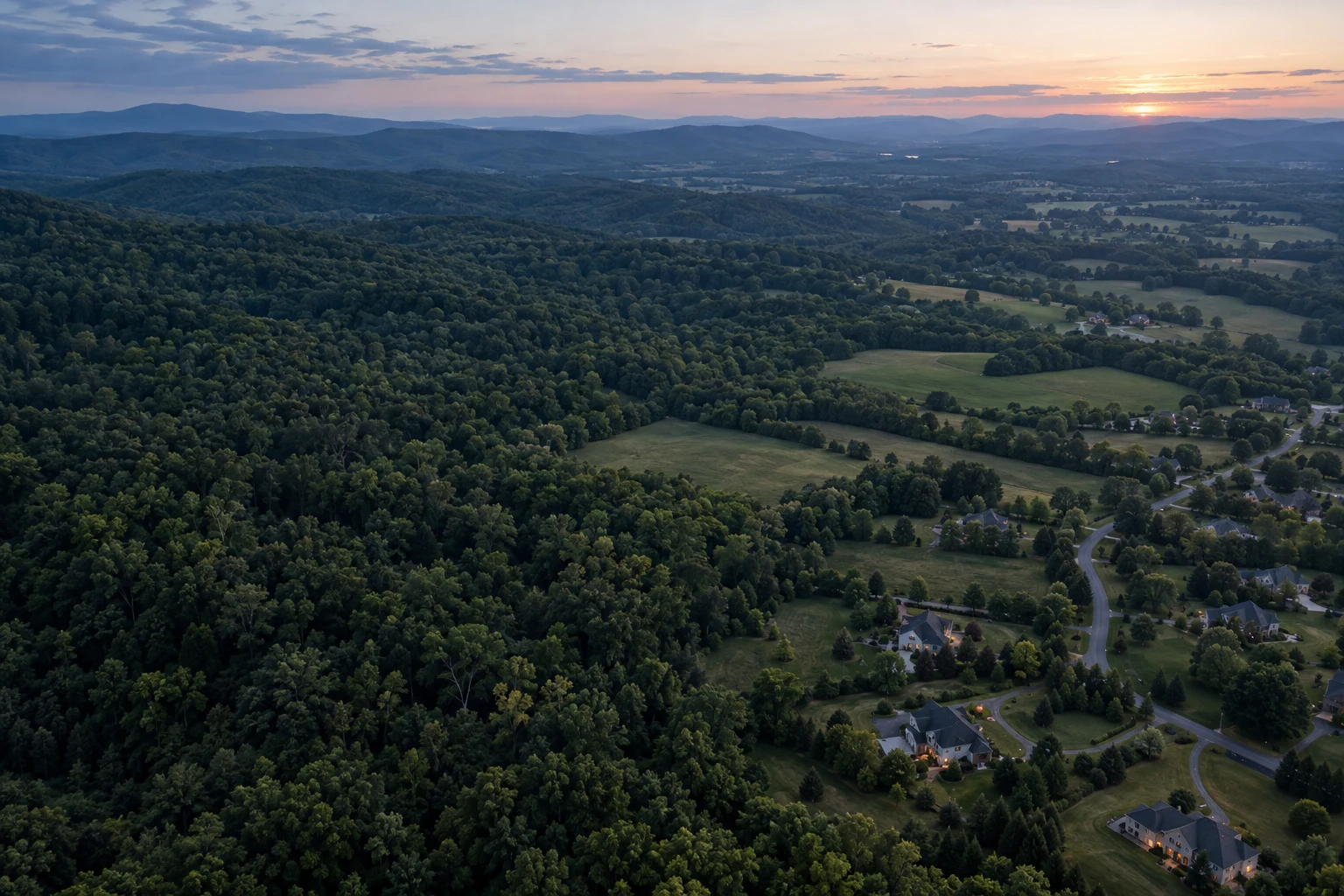 Conceptual aerial landscape of woodland, open land, and a residential neighborhood.