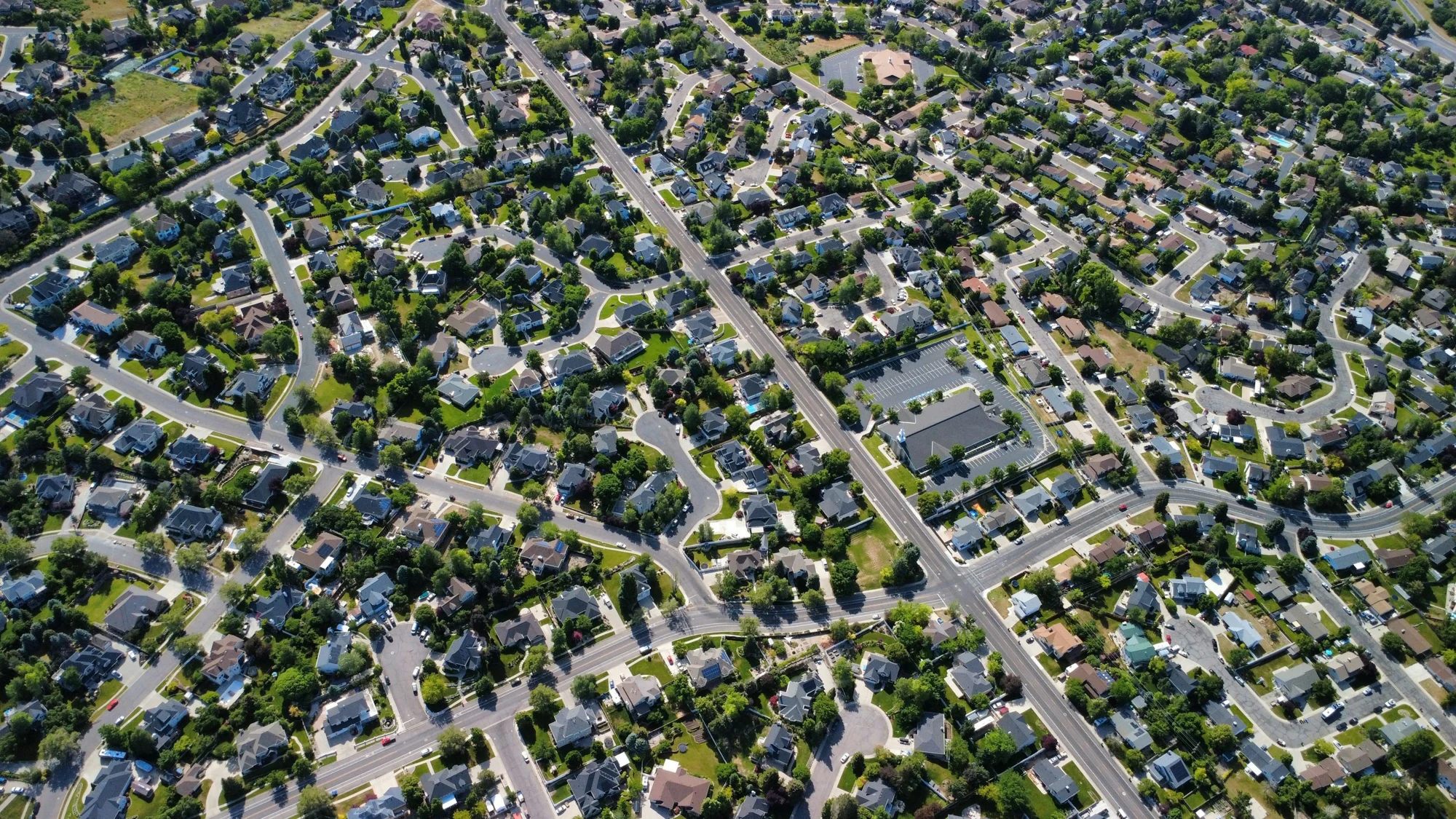 Aerial view of a planned residential neighborhood and its surrounding landscape.